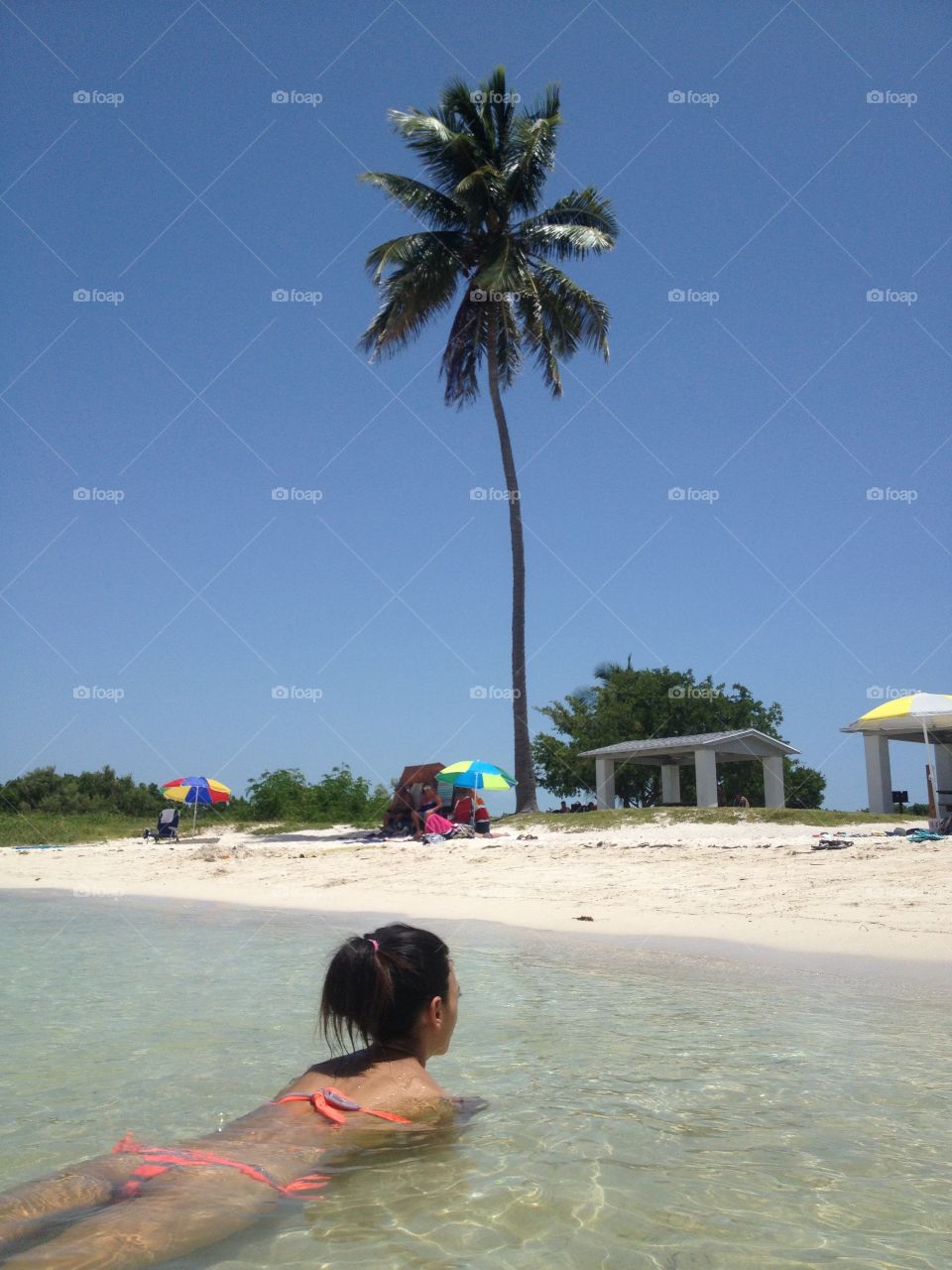 Woman into trasparent sea,keys,Florida. Relax into the light blue water in a day at Bahia Honda,Florida