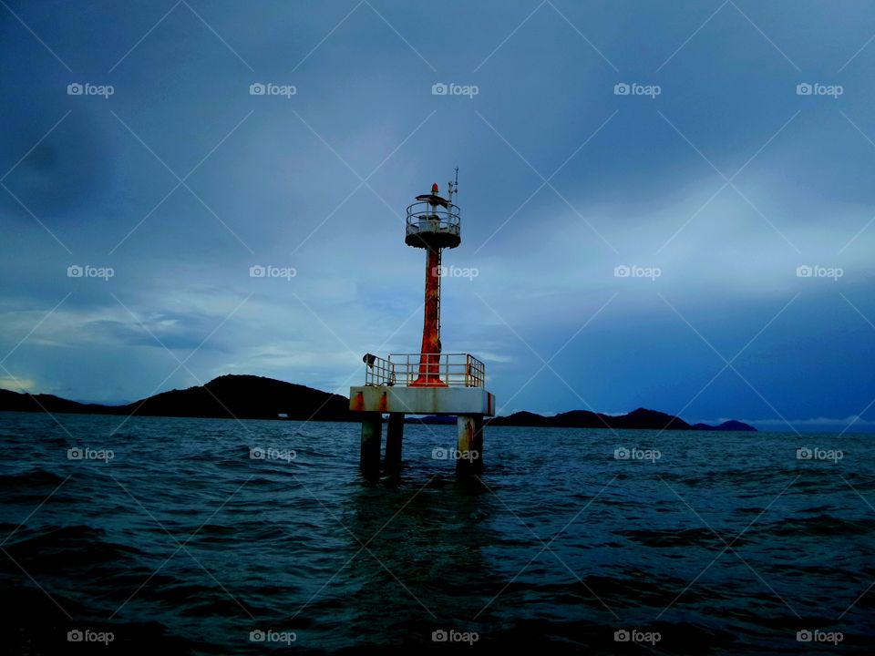 Alone light. The light house is still stand over night for assist all seaman to find the right way.