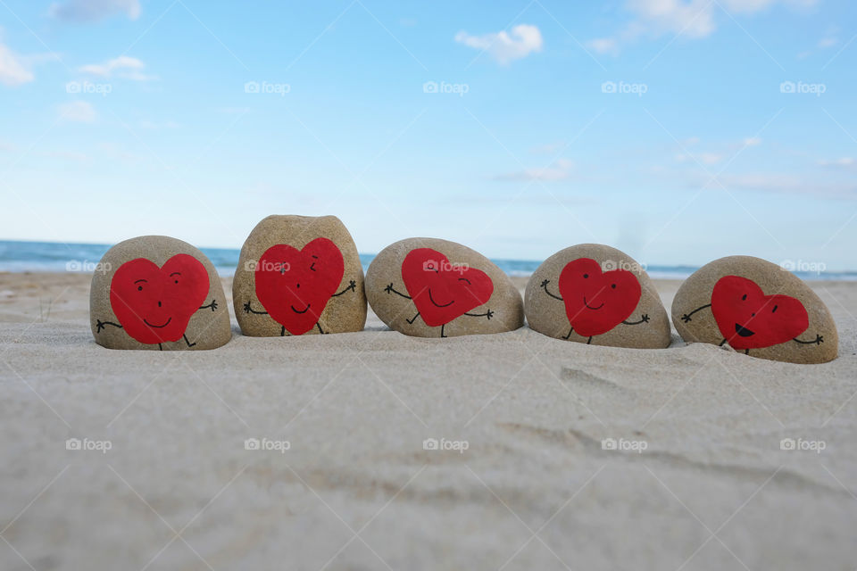 Red heart stones on the beach