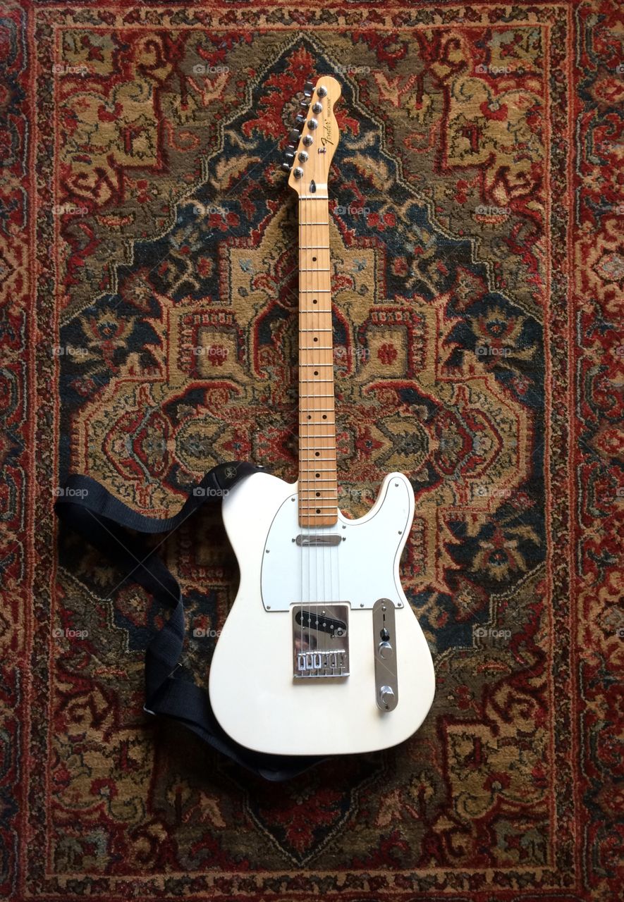 Fender telecaster on a Kashan. Fender telecaster guitar on a Kashan hand woven rug
