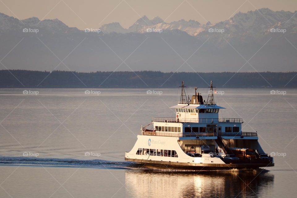 An inner island commuter ferry travels across the cold blue waters of Puget Sound on a beautiful winter afternoon 