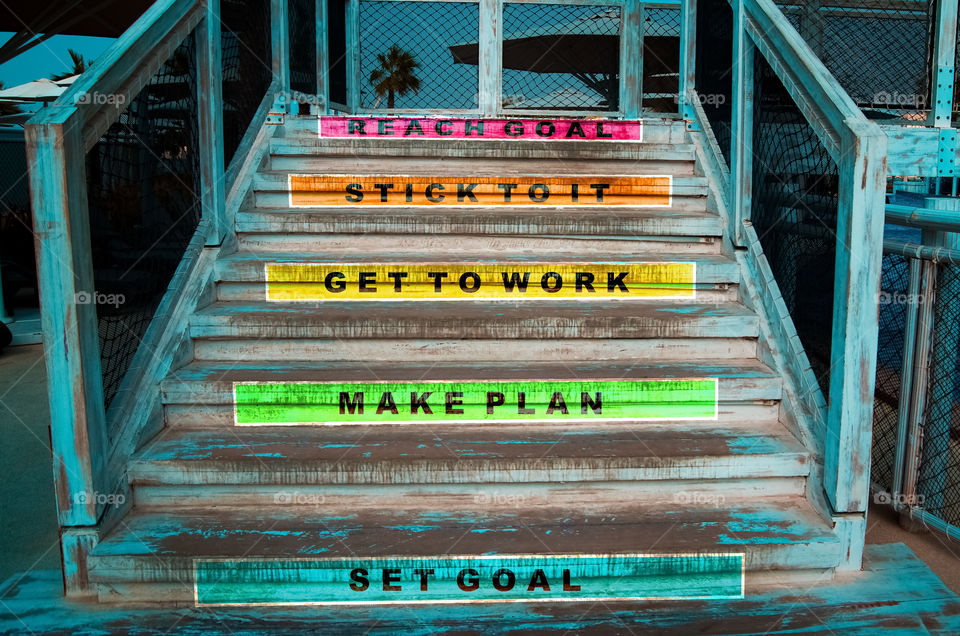 Steps on how to reach goal painted on the stairs.