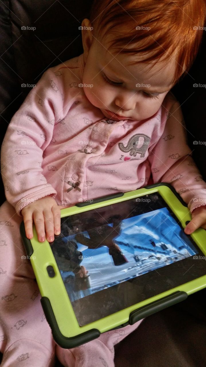 Cute boy watching movie on his tablet