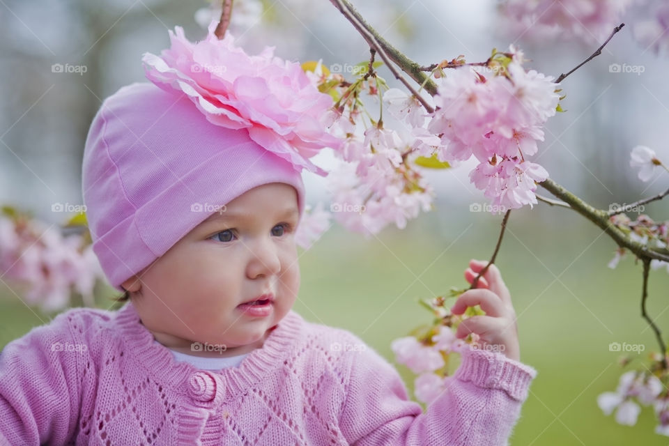 Little girl in a blossom park