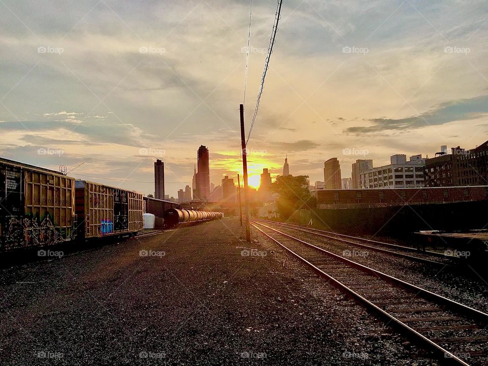 Yet another view of the train tracks running underneath the Pulaski Bridge and parallel to Borden Ave in LIC, Queens, NY photographed at dusk and upcoming nightfall. 2021. Hypnotic Productions