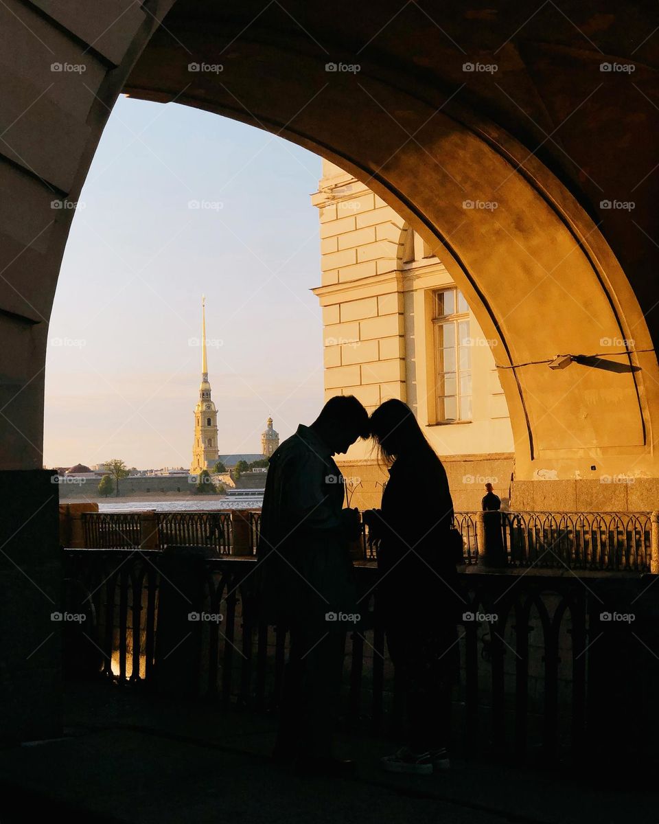 Lovers on a sunset in beautiful city, light and shadow 