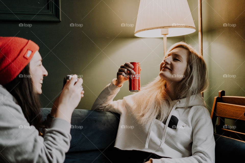 girls having fun with camera and coca cola