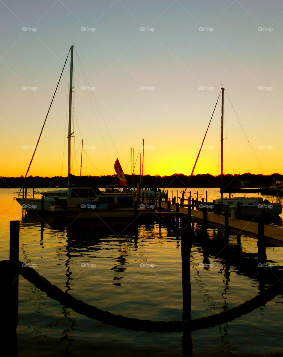 Yacht parking at harbor during sunset