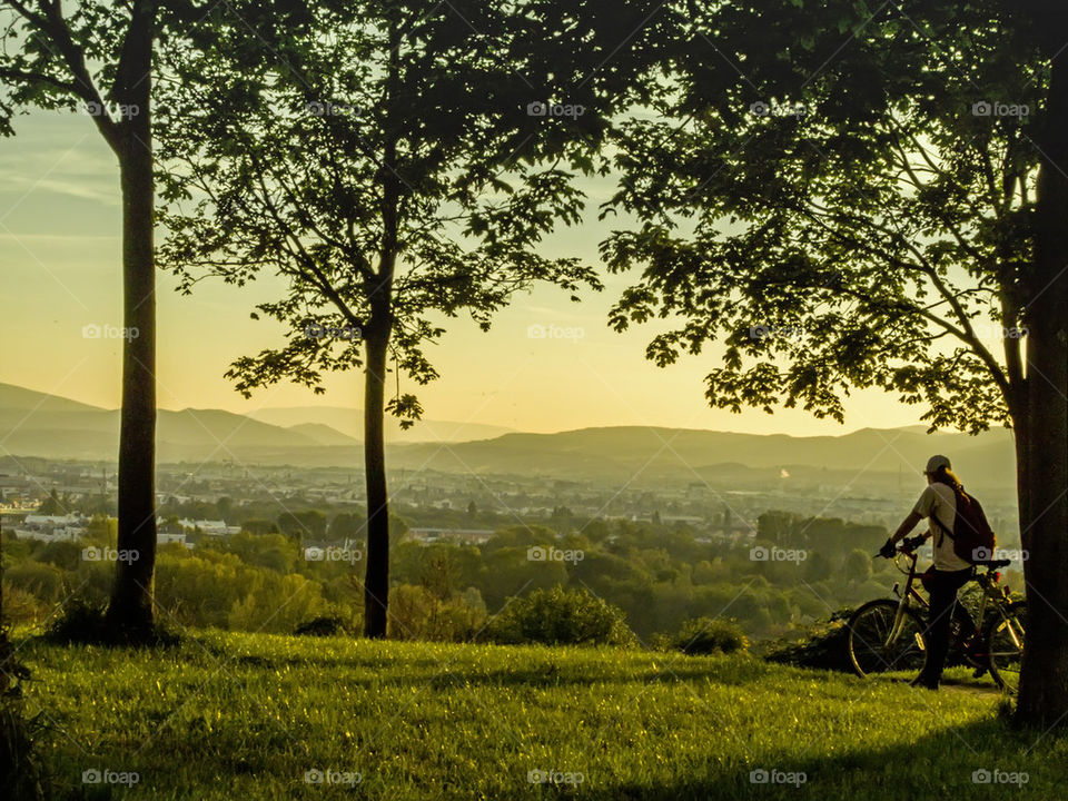 Rear view of person standing against city