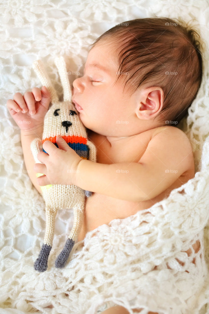 Close-up of baby sleeping with soft toy