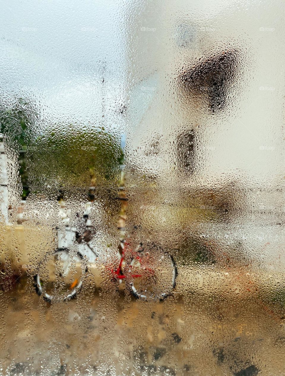 Bicycle through the wet window 