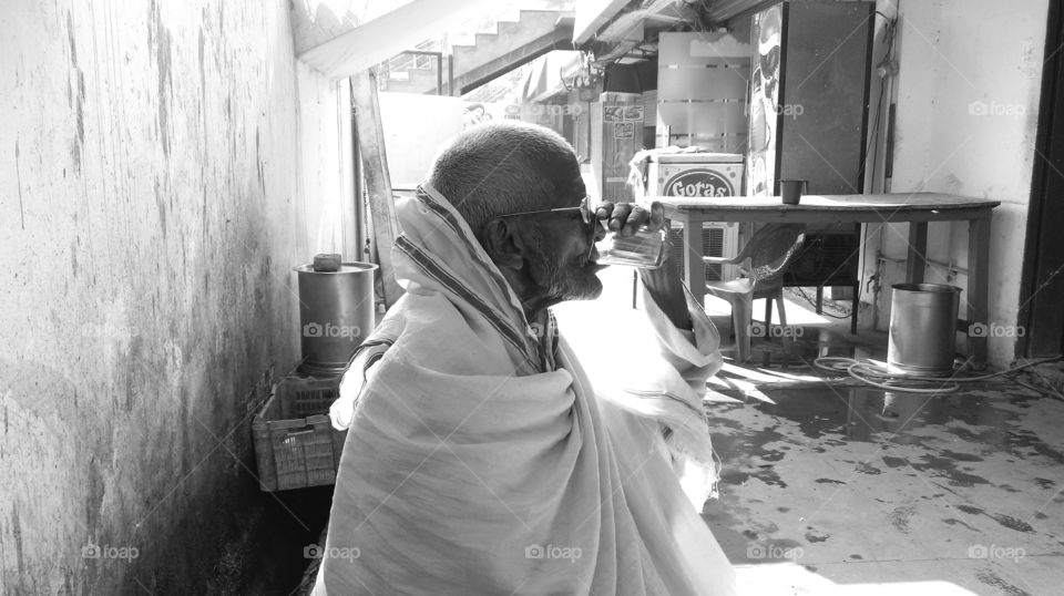 Gandhi like looking old chap on his daily chai break in central Baranas...