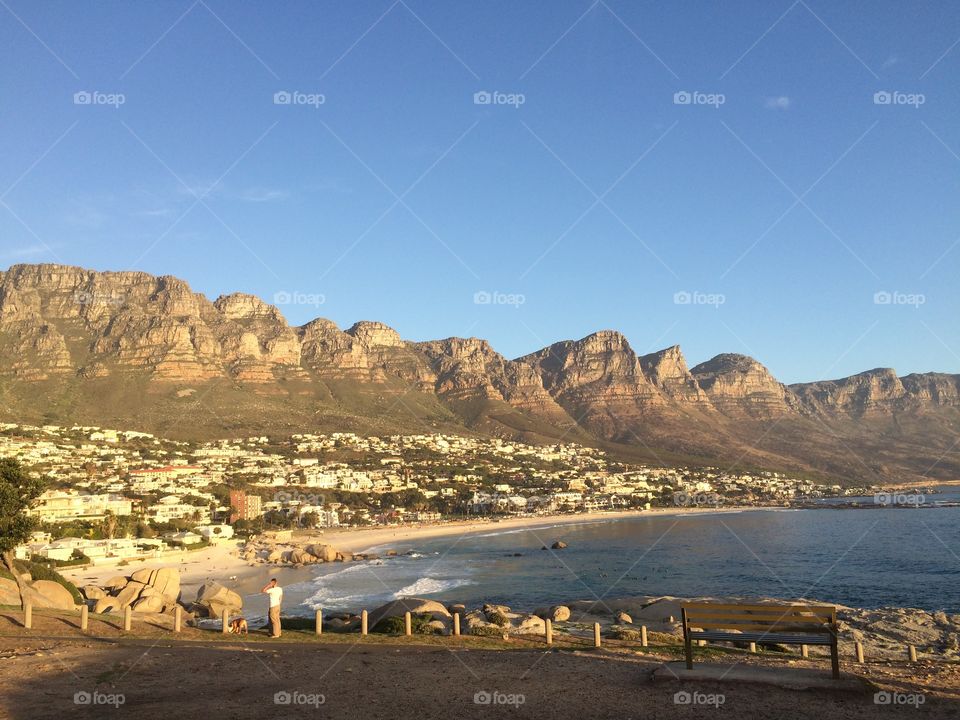 Sunset views over Camps Bay and the twelve Apostle mountains forming Table Mountain National Park in Cape Town South Africa 