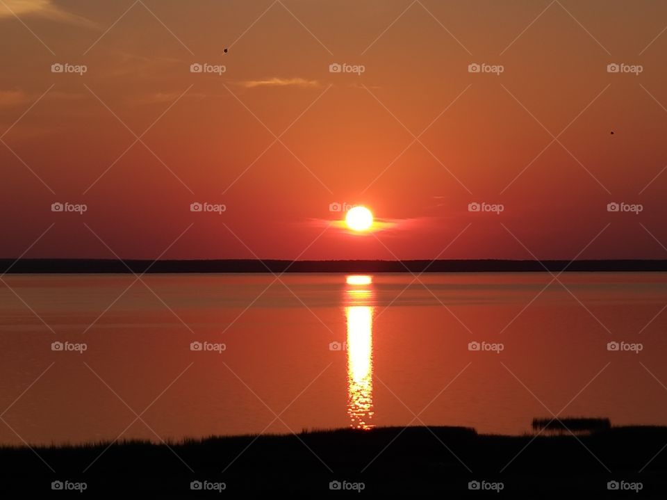 Beautiful bright red sunset on the lake