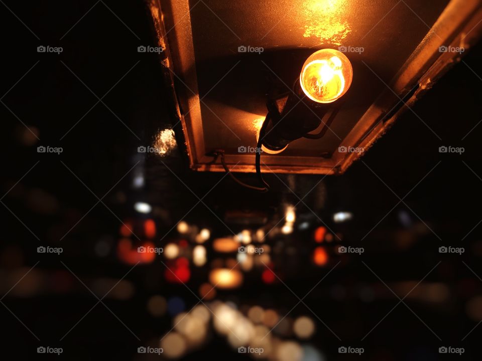 Light bulb on the ceiling of rooftop. Shot on minibus.