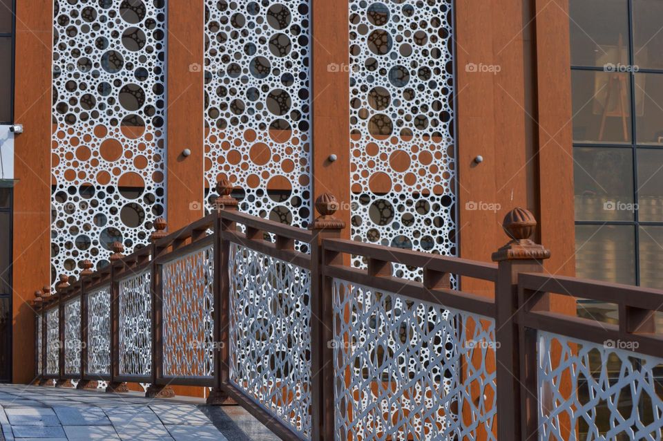 the facade of the building finished with coating with large and small circles.