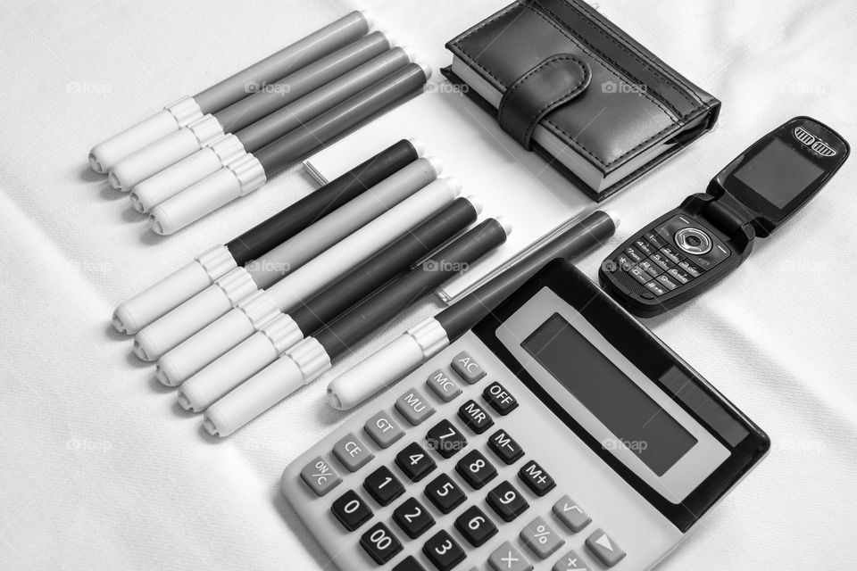 Calculator,cell and markers. Office equipment on the table