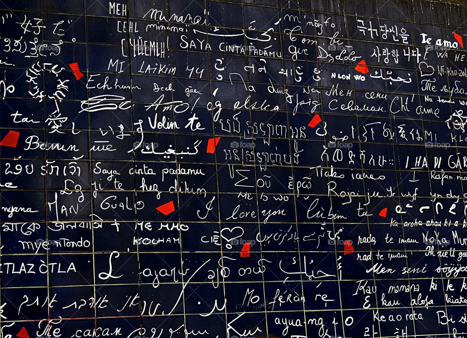 I Love You Wall located Paris, France. It features the phrase "I love you" written 311 times in 250 different languages. The orange splashes on the wall represent broken hearts, symbolizing a world that needs to be reunited. 