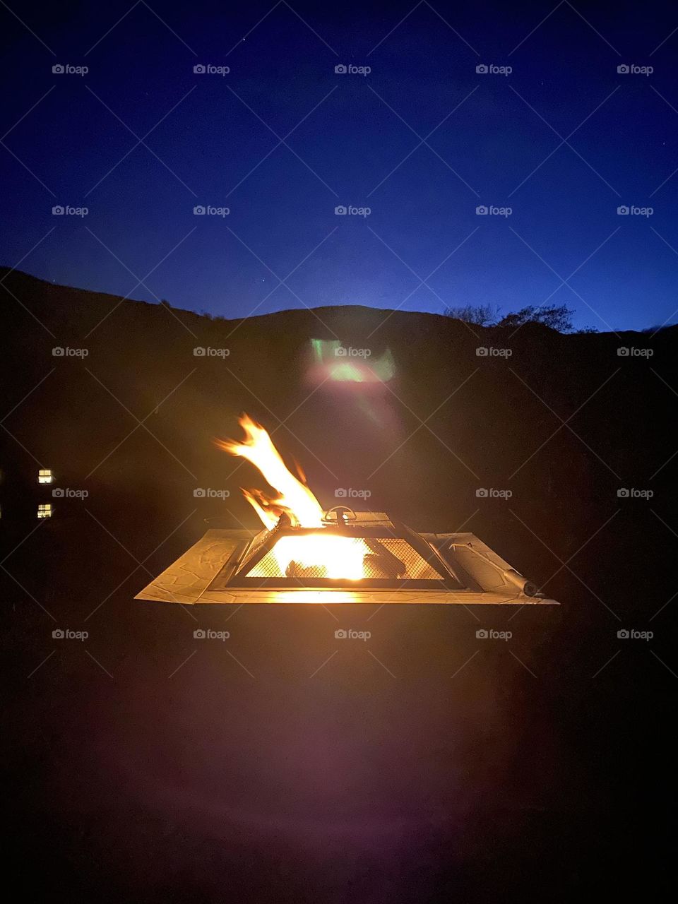 Fire pit I front of hills at sunset