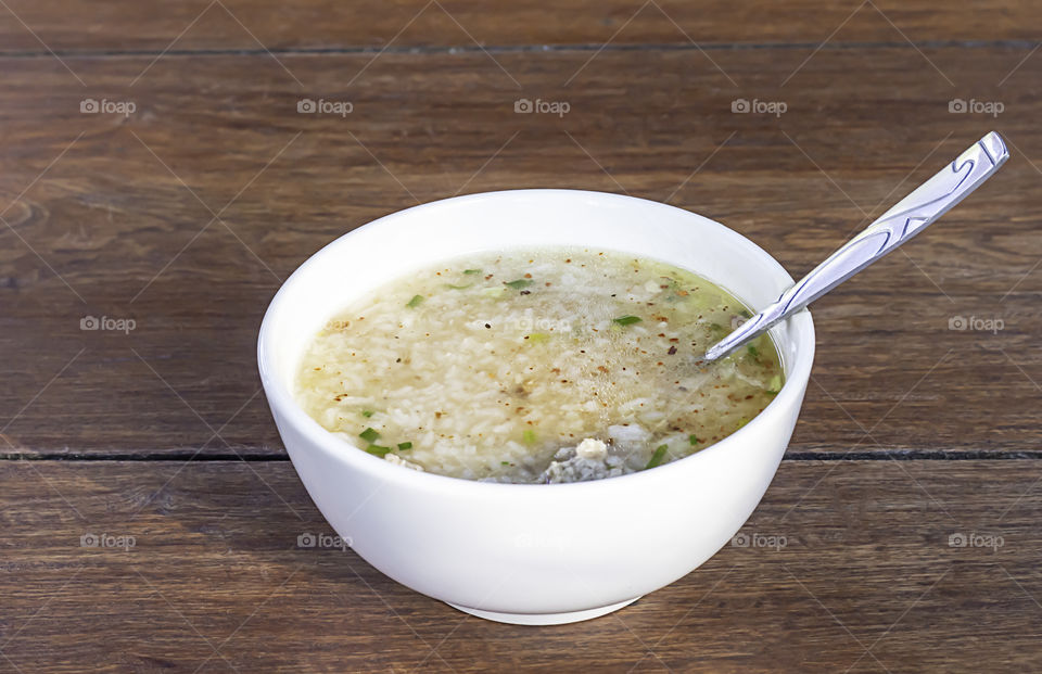 Boiled pork in white bowl on wooden table eat breakfast.