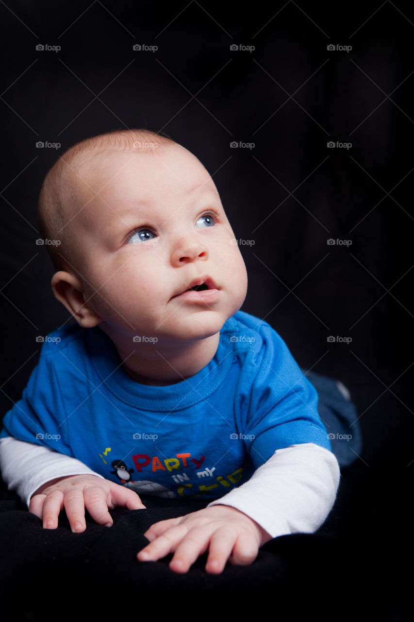Baby boy on black background 