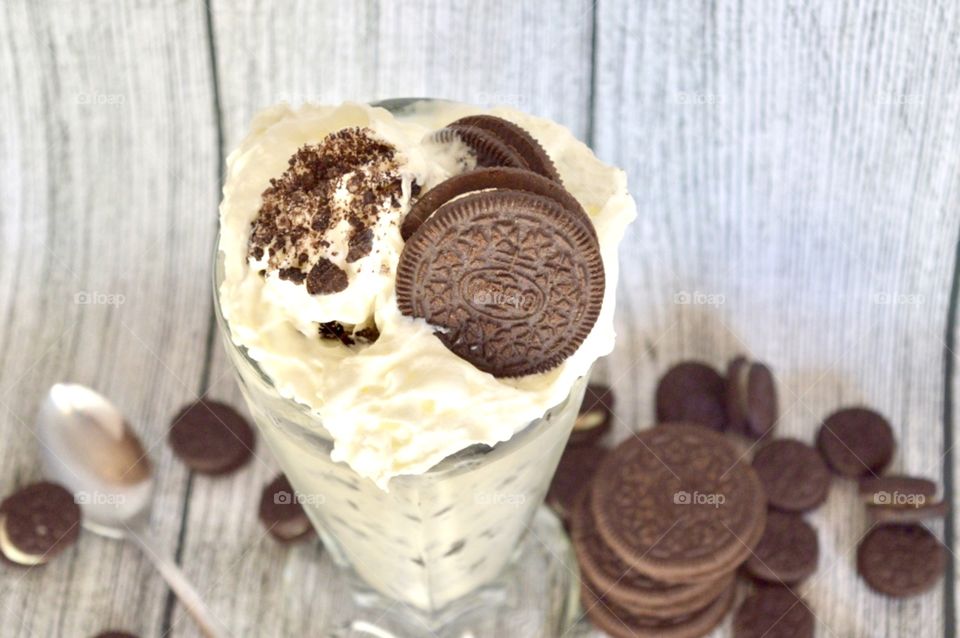 Oreo cookie milkshake with a wooden rustic white background