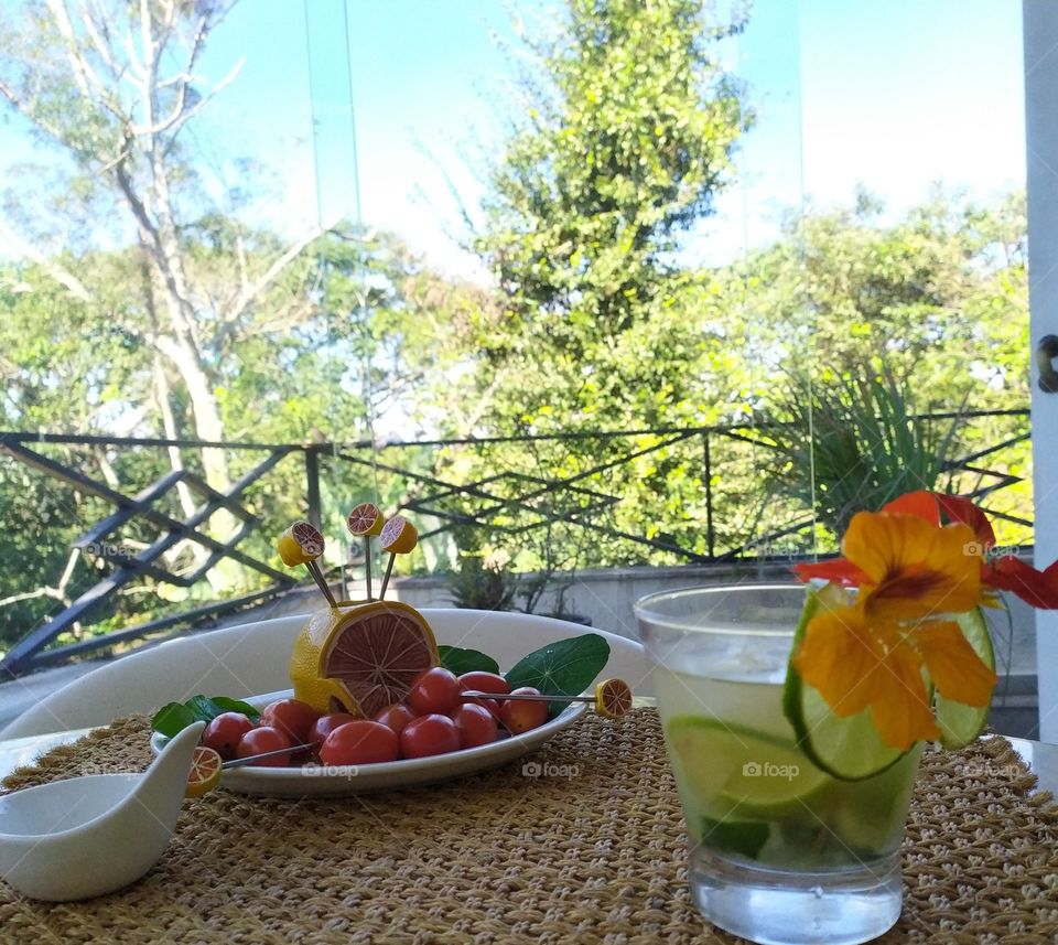 A Summertime day to admire with a special Glass of a Brazilian caipirinha and lovely little tomatoes