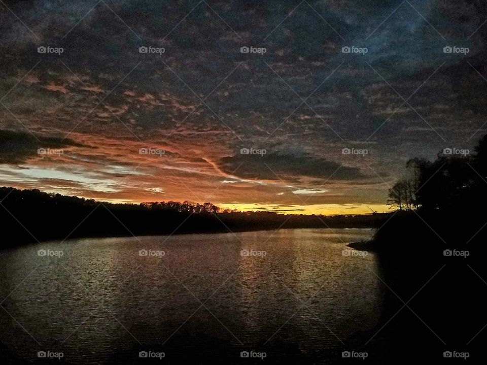 dramatic sunset over lake.