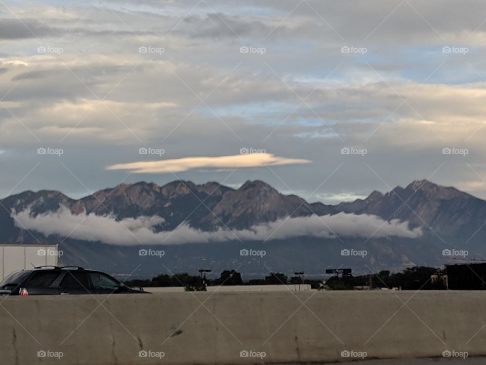 low letting clouds strung out beautifully across a mountain range.