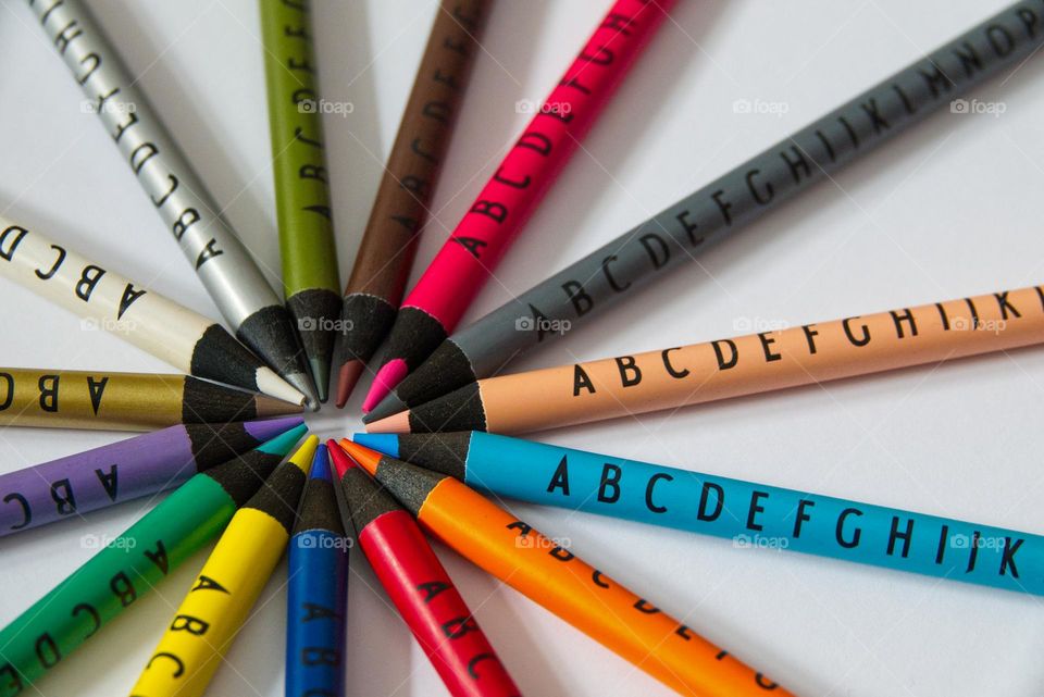 Colored design crayons arranged in a circle shape.