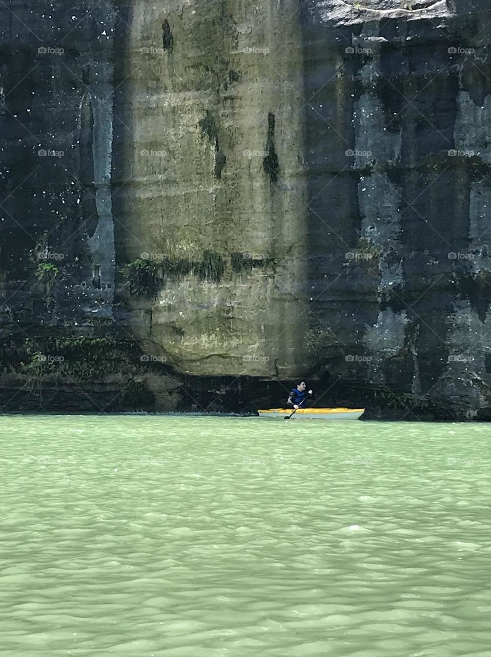 Kayaking in the Buffalo River near cliff face
