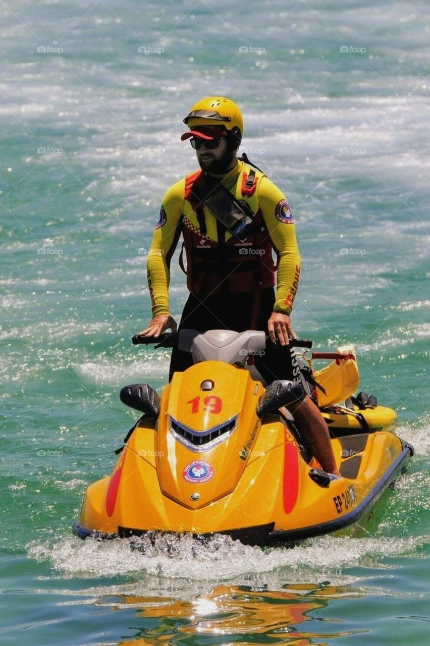 Surf lifesaver patrolling the coast.