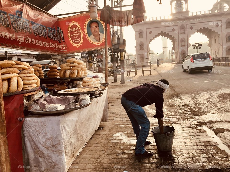 Street Food Vendor cleaning up before he starts work (India)