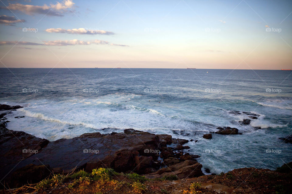 surfing waves and rocks in Wollongong, NSW, Australia