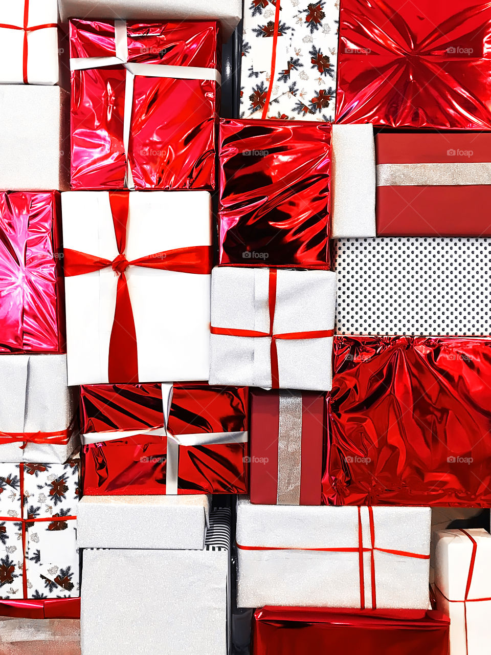 Colorful festive background made of red and white gift boxes with red and white stripes 