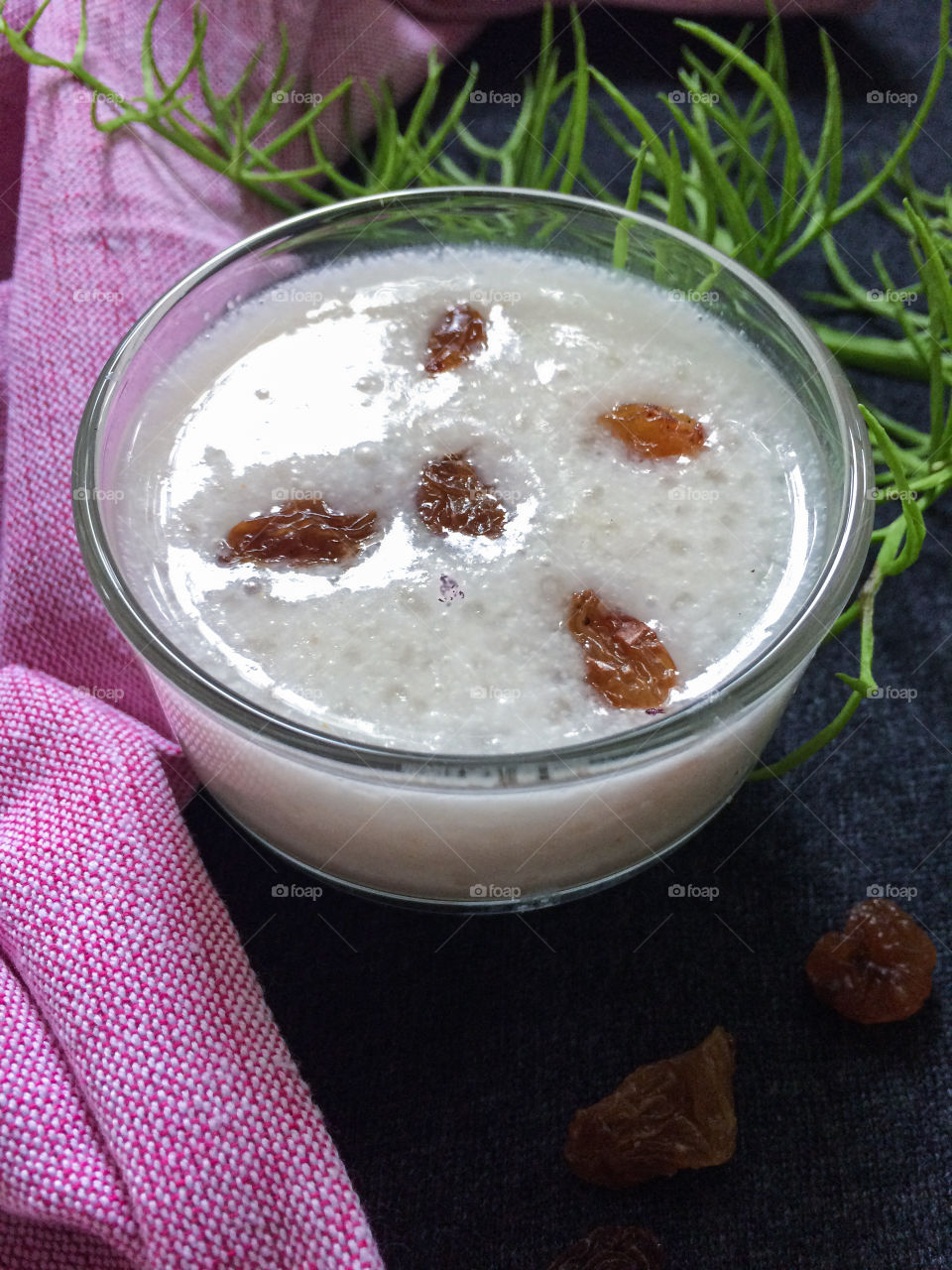 Sweet  sago porridge  made from sago, coconut milk and sugar , garnished with raisins .
