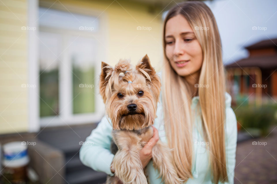 Beautiful woman with Yorkshire terrier outdoor 