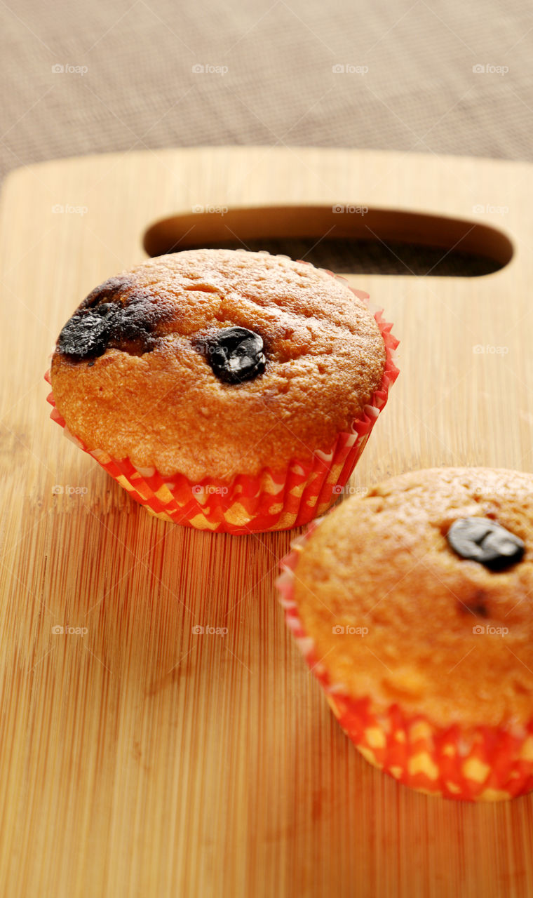 Cup cake muffins on a wooden board