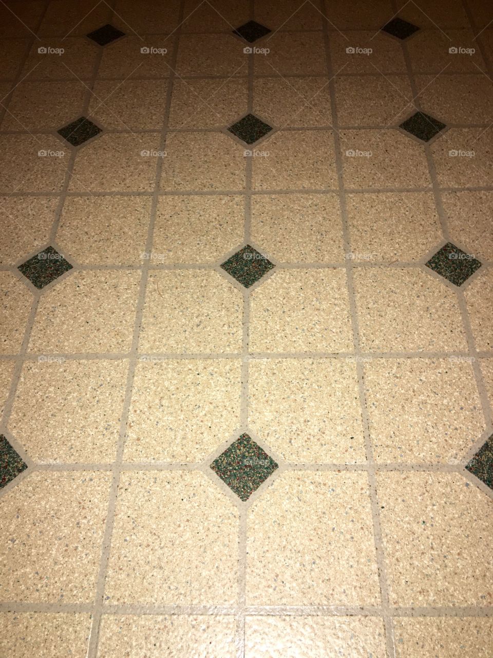 Flooring, light tan color with green accents.