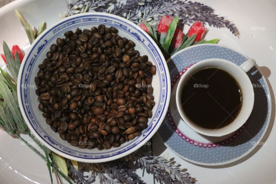 A cup of coffee and coffee beans