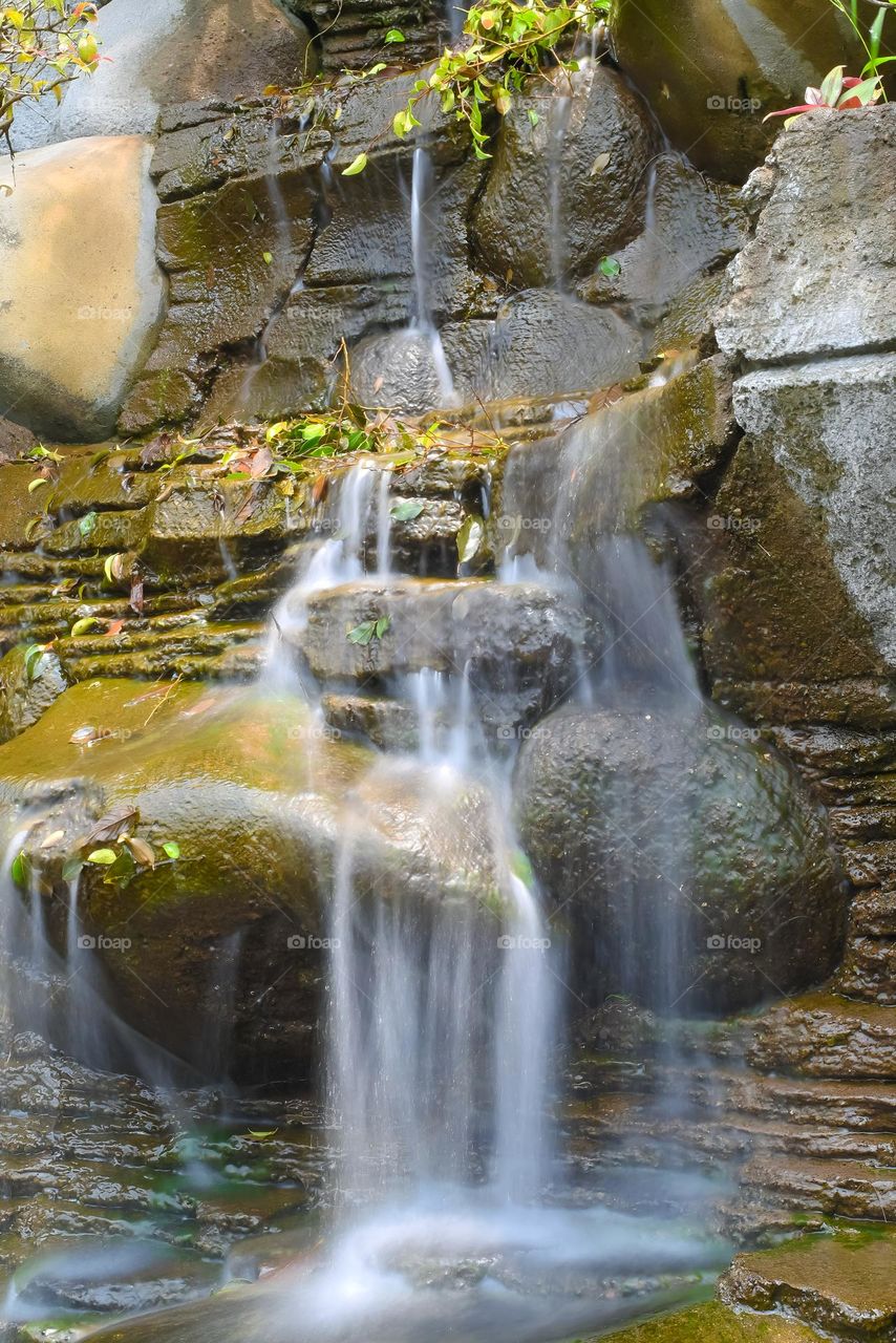 long exposure small waterfall in a beautiful garden in Bali, Indonesia