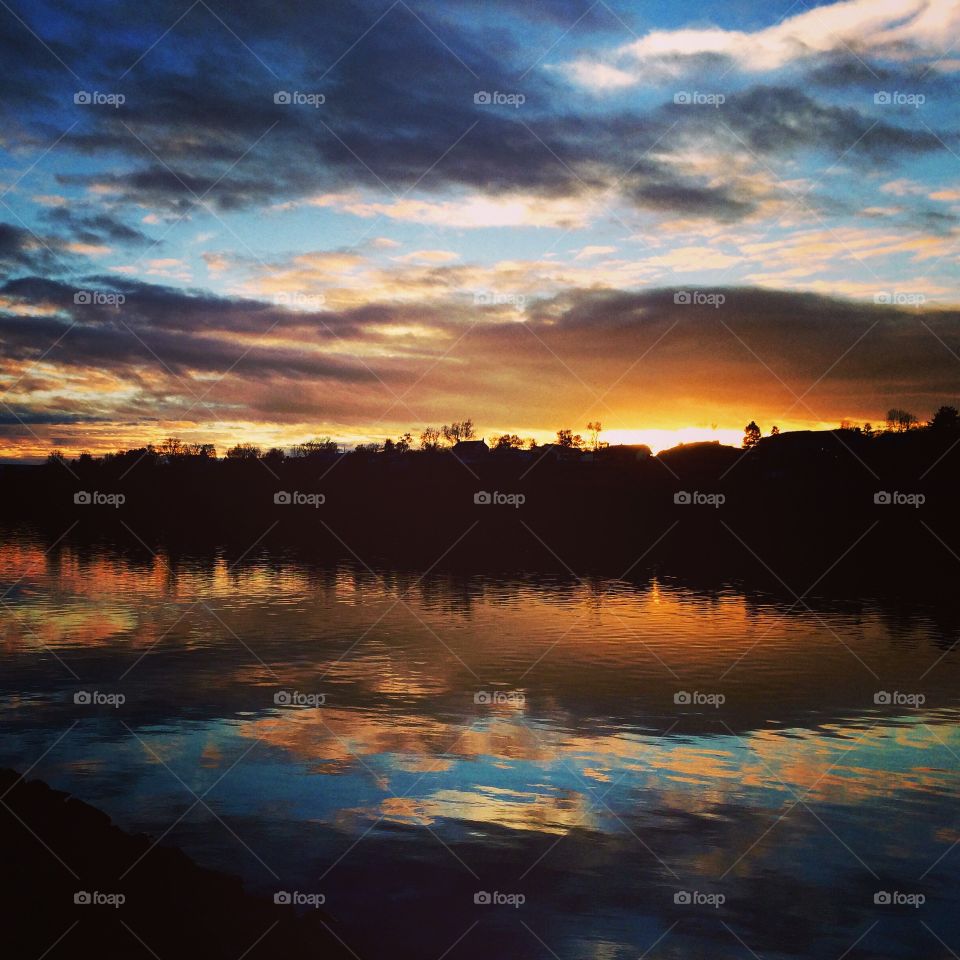 Clouds reflecting on sea during sunset