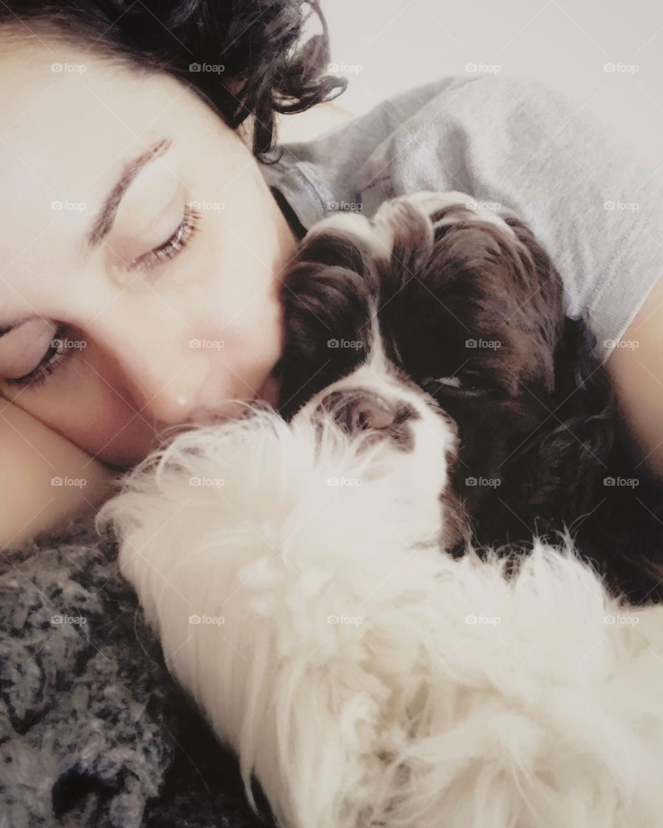 Puppy doesn’t like to be disturbed when sleeping with her mommy!