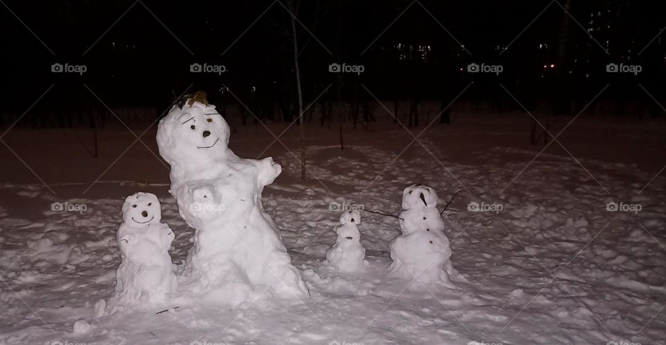 snowman family night view in park Christmas and New year holiday