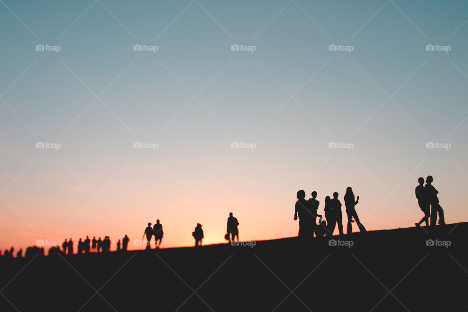 People walking at sunset