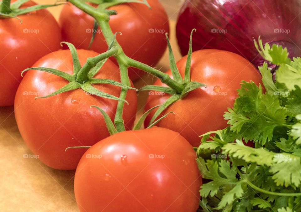 Tomato cilantro onion on cutting board