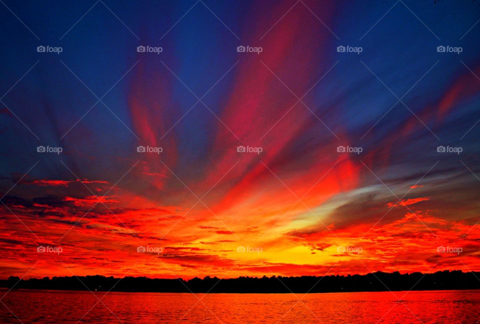 Fire in the sky over the shimmering bay waters. It's the silky, smooth collusion of skyburst reds, oranges and yellows into the calm of night.  It is also a symphony of color as it sings us all to sleep. 