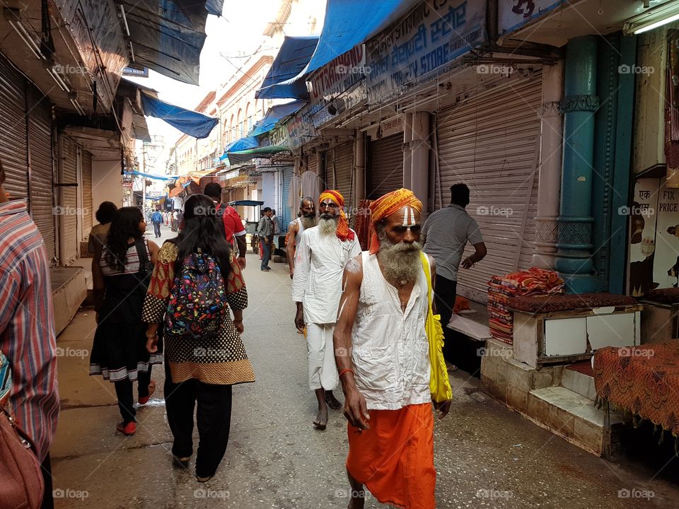 devotees walking through a market to ganga river to take bath.