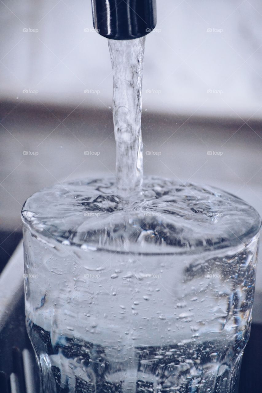 Water pouring into drinking glass