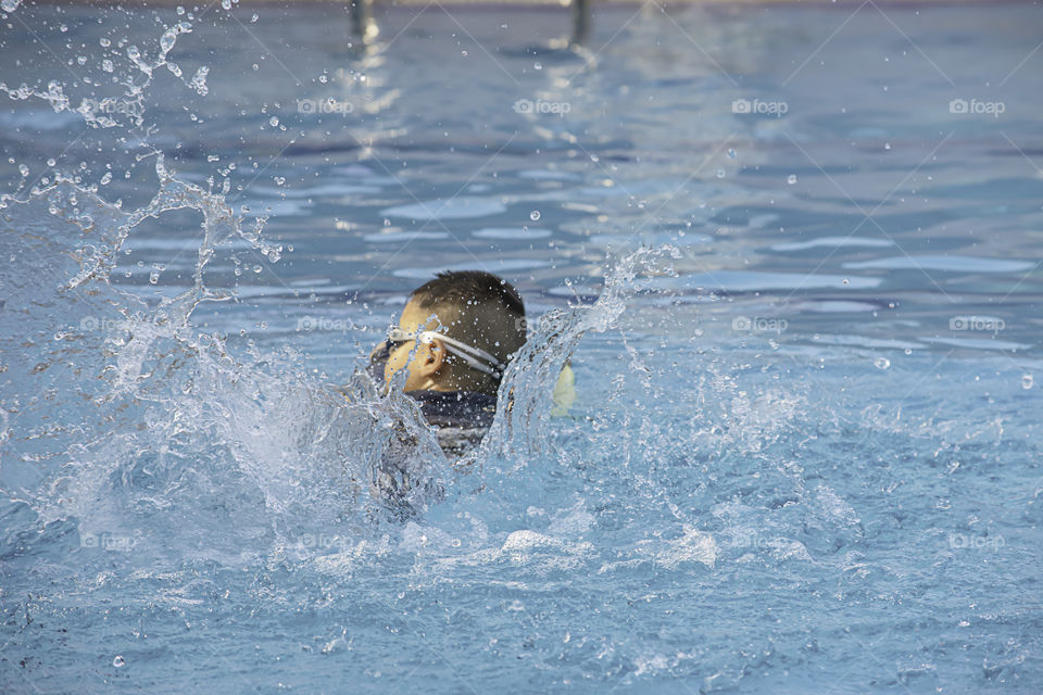 Asean boys are swimming in the pool.
